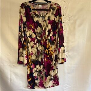 Venus’s floral dress in shades of purple, yellow, gray, and cream.